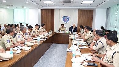 Police officers and officials in a meeting room discussing drug eradication strategies, highlighting poli.