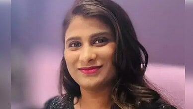 A woman in traditional attire smiling, with a blurred background, representing a Telugu woman in Florida.