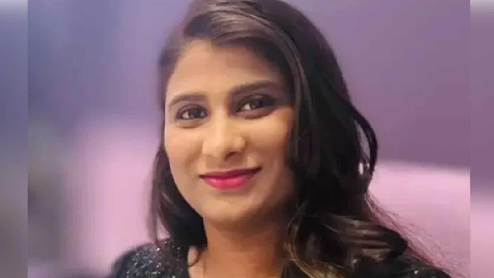 A woman in traditional attire smiling, with a blurred background, representing a Telugu woman in Florida.