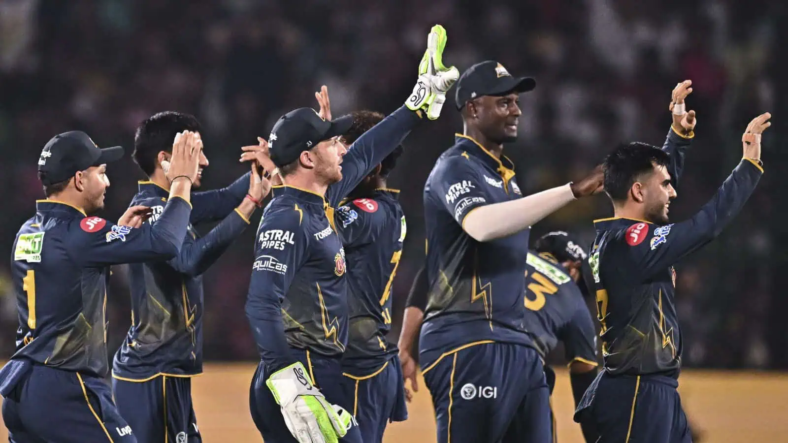 The Siasat Daily, cricket players celebrating on the field after a successful match.