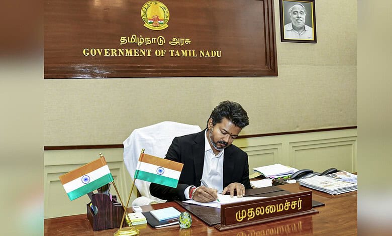 Indian government official signing documents at Tamil Nadu government office, promoting new schemes for p.