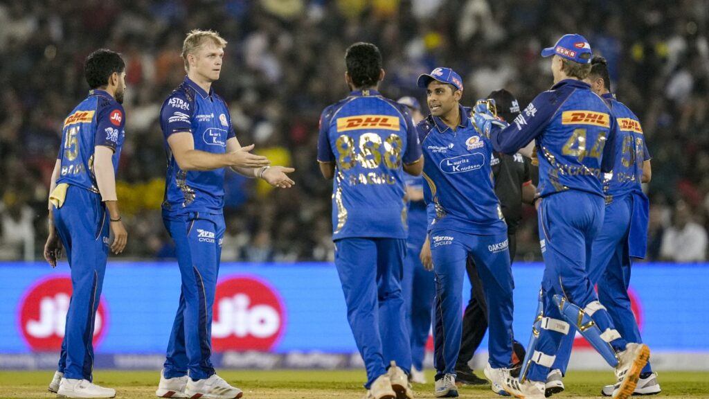RCB cricket team celebrating last-ball IPL victory against MI in a tense match.