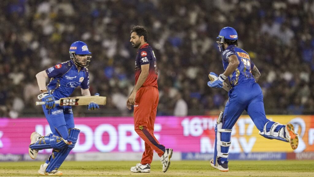 RCB players celebrate a last-ball victory over MI in an IPL match thriller.