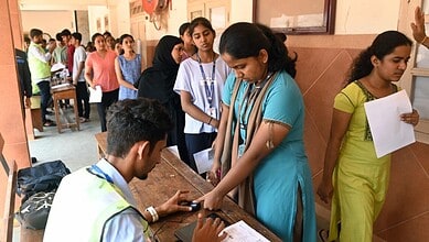 NEET-UG exam students waiting in line at a registration desk, reflecting exam cancellations and student c.