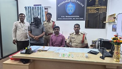 Police officers and staff members seated and standing in Hyderabad City Police office, Hyderabad, Telanga.