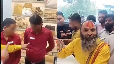 A man with a beard and traditional attire, holding a stick, surrounded by a group of people in a shop or.