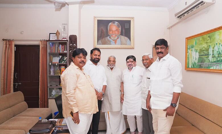 Celebrating Indian leaders in a modern office setting with a portrait of Narendra Modi in the background.