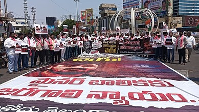 Protest march in Hyderabad demanding justice and rights, with participants holding banners and placards i.