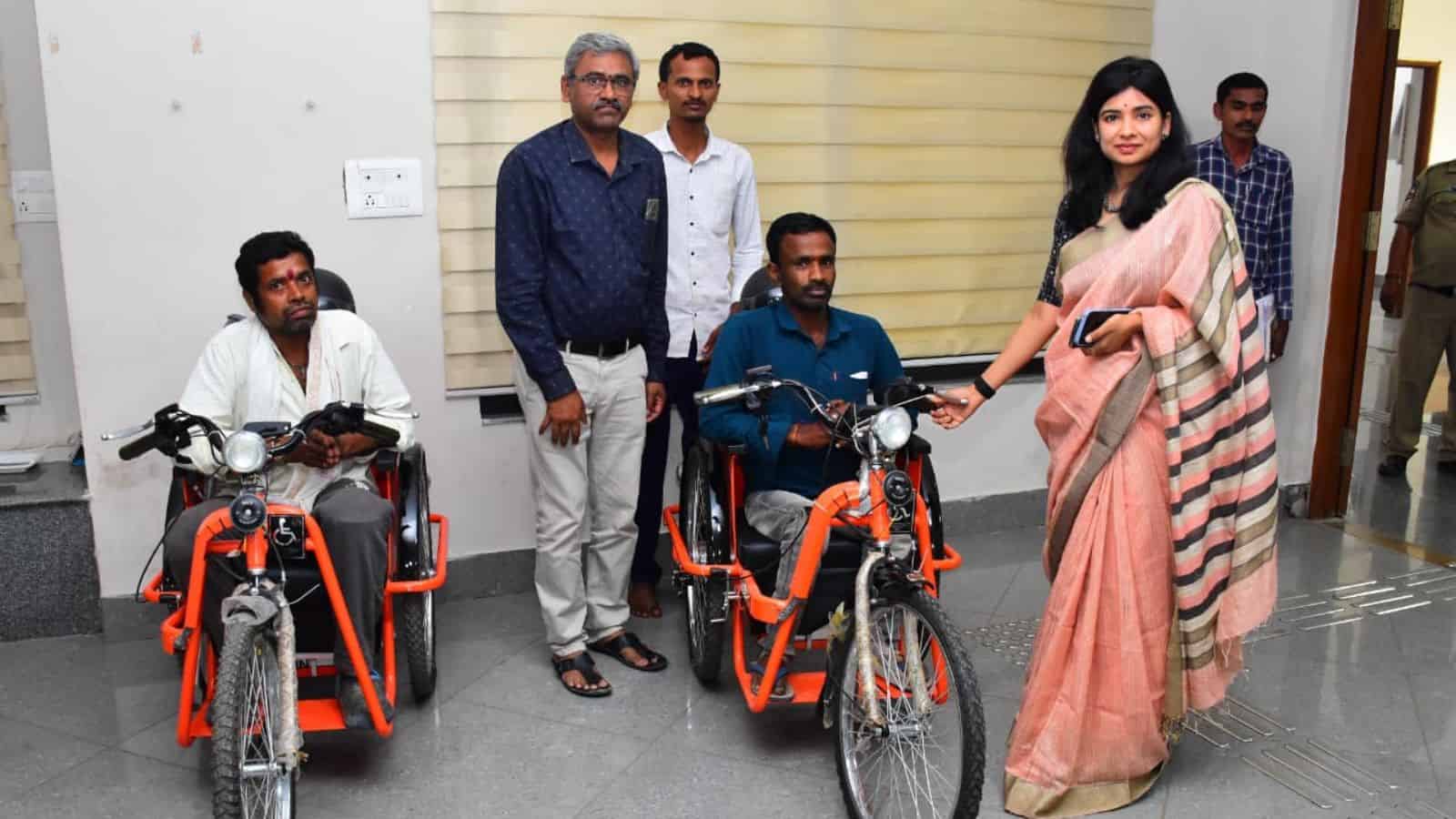 Accessible transportation initiative with individuals using adaptive bikes and supportive staff.