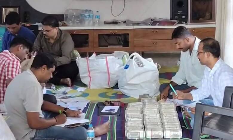 ACB officials count cash seized from the general manager's house