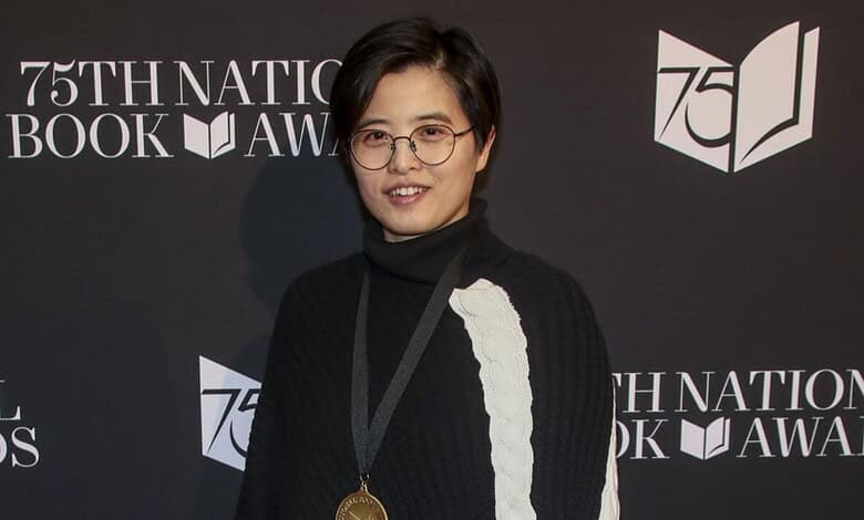 A woman with short black hair and glasses smiling at the 75th National Book Awards event.