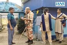 Security guard checks a voter's slip in West Bengal