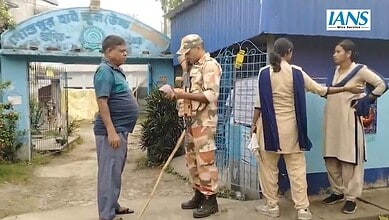 Security guard checks a voter's slip in West Bengal