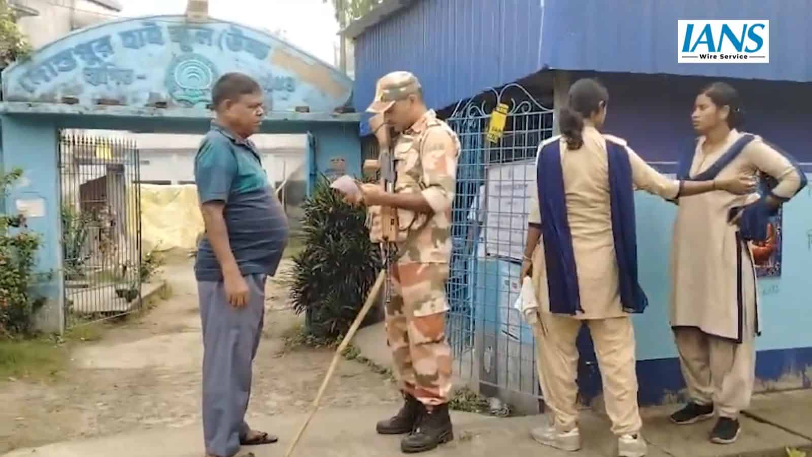 Security guard checks a voter's slip in West Bengal