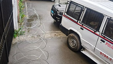 A police vehicle outside Sajad Lone's house