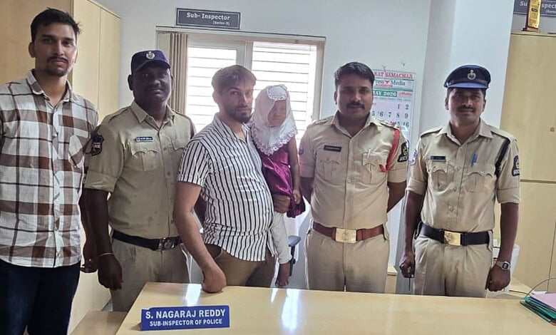 Group of police officers and civilians posing together in an office setting.