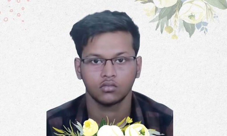 A young man wearing glasses with a neutral expression, against a light background with floral accents.