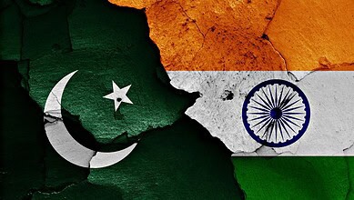 Pakistan and India flags painted on cracked wall, symbolising regional relations and cultural diversity.