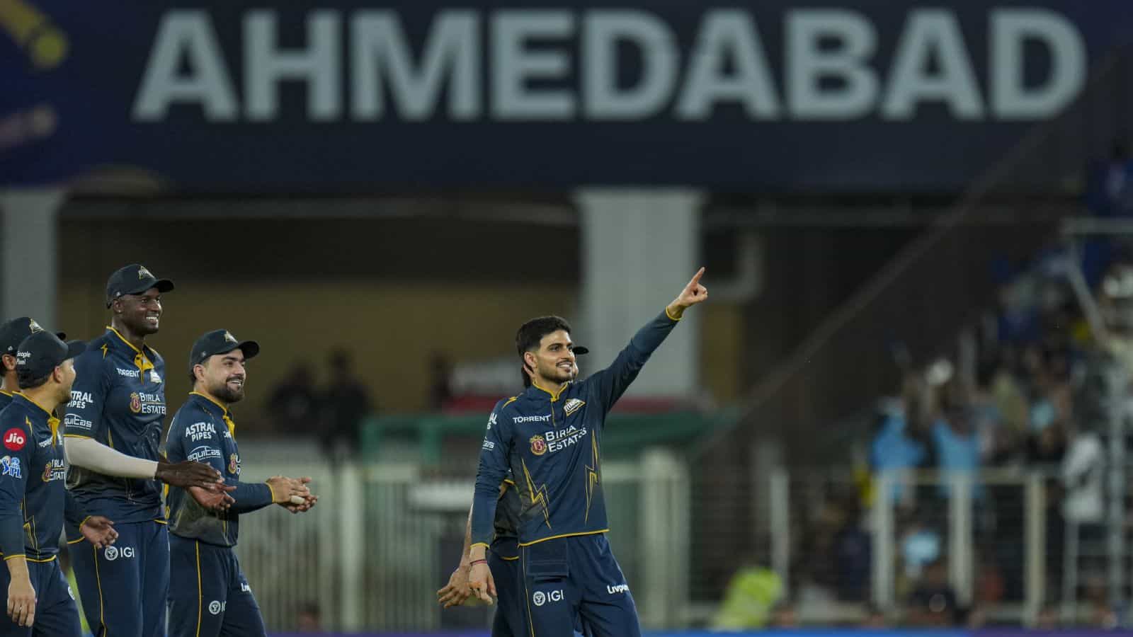 A cricket player from Gujarat Titans celebrating after a successful match at Ahmedabad stadium.