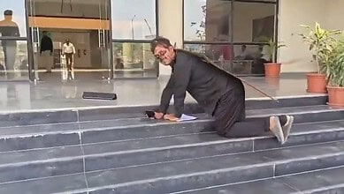An activist dresssed as cockroach approaches Mathura corporation