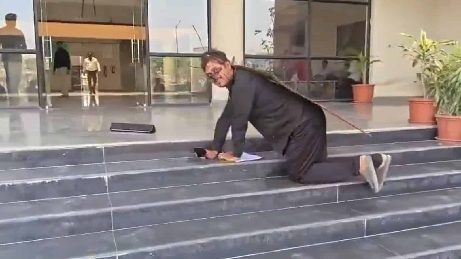 An activist dresssed as cockroach approaches Mathura corporation