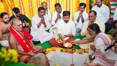 Traditional Indian religious ceremony with priests and devotees during a spiritual event.
