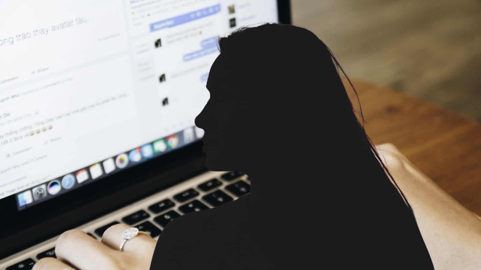 SEO-friendly ALT tag: Person working on a laptop with social media and messaging apps open on the screen.