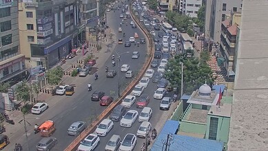 A busy urban street with heavy traffic and tall buildings in a cityscape.