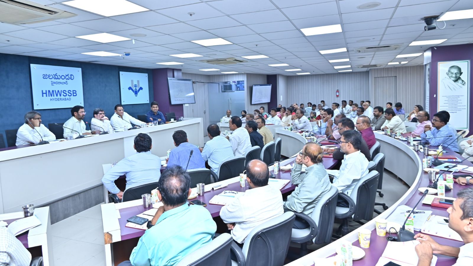A detailed conference room with professionals attending a formal meeting at The Siasat Daily event.