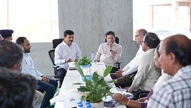 Senior officials and journalists engaged in a discussion during a formal meeting at The Siasat Daily offi.