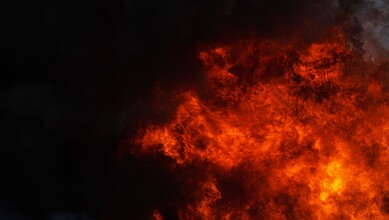 A fiery explosion with intense flames and smoke, creating a dramatic and dangerous scene.