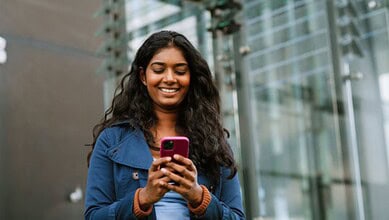 An Indian woman using a mobile phone used for representational purposes