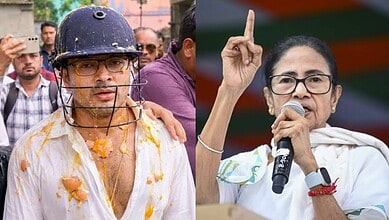 A man wearing a helmet and glasses covered in yellow food, with a crowd in the background.