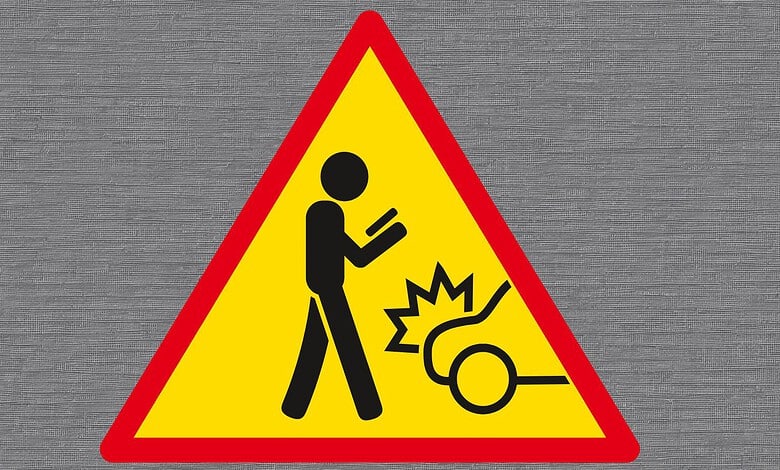 Caution sign warning of a falling object or hazard with a person and an impact symbol.