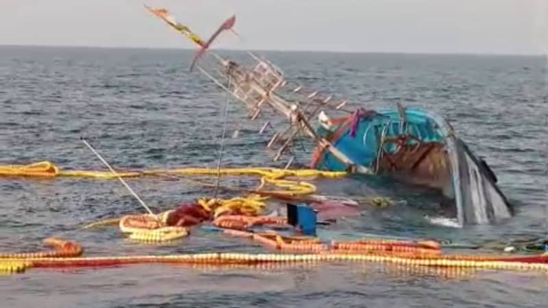 A sinking fishing boat off Goa coast with 22 fishermen rescued in the background.