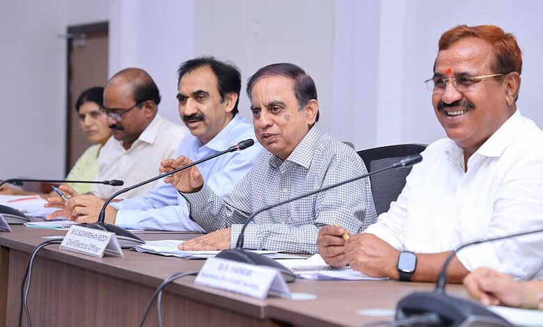 Senior officials and government representatives seated at a conference table during a formal meeting.