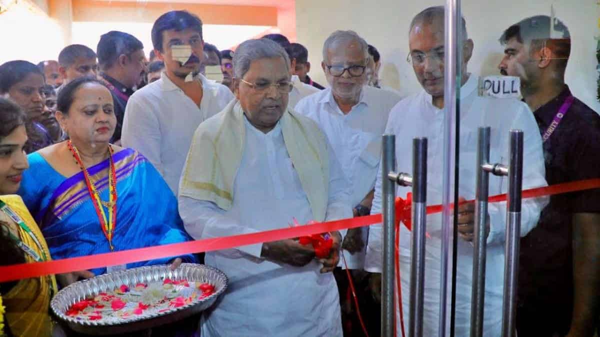 Prominent Indian leader inaugurating a new facility with diverse group of officials and attendees.