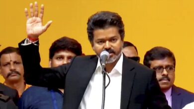 Vijay as 'Muthalvan' from 'Thalapathy' during a public event, showcasing his powerful transformation and.
