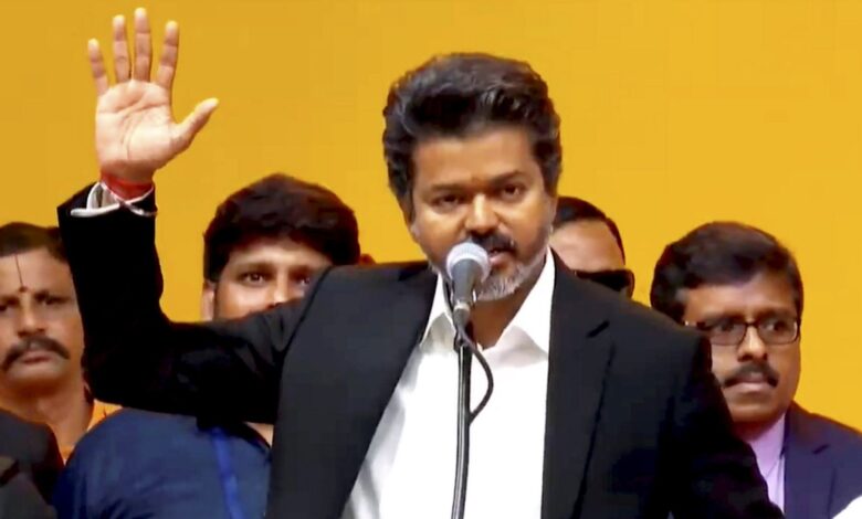 Vijay as 'Muthalvan' from 'Thalapathy' during a public event, showcasing his powerful transformation and.
