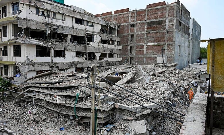 Building collapse aftermath in urban area, debris and damaged structures.