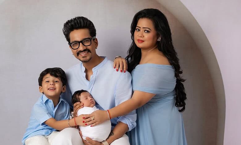 A happy family portrait of parents with two children, celebrating a joyful moment indoors.