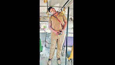 Shorter TGSRTC conductor using mobile phone inside bus, highlighting alternative roles for height-challen.