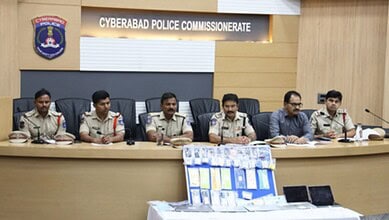 Police officers seated at a conference table during a meeting at Cyberabad Police Commissionerate.