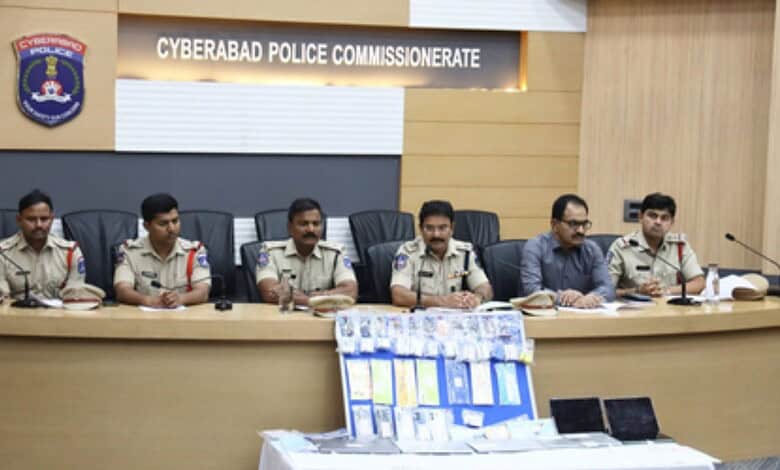 Police officers seated at a conference table during a meeting at Cyberabad Police Commissionerate.