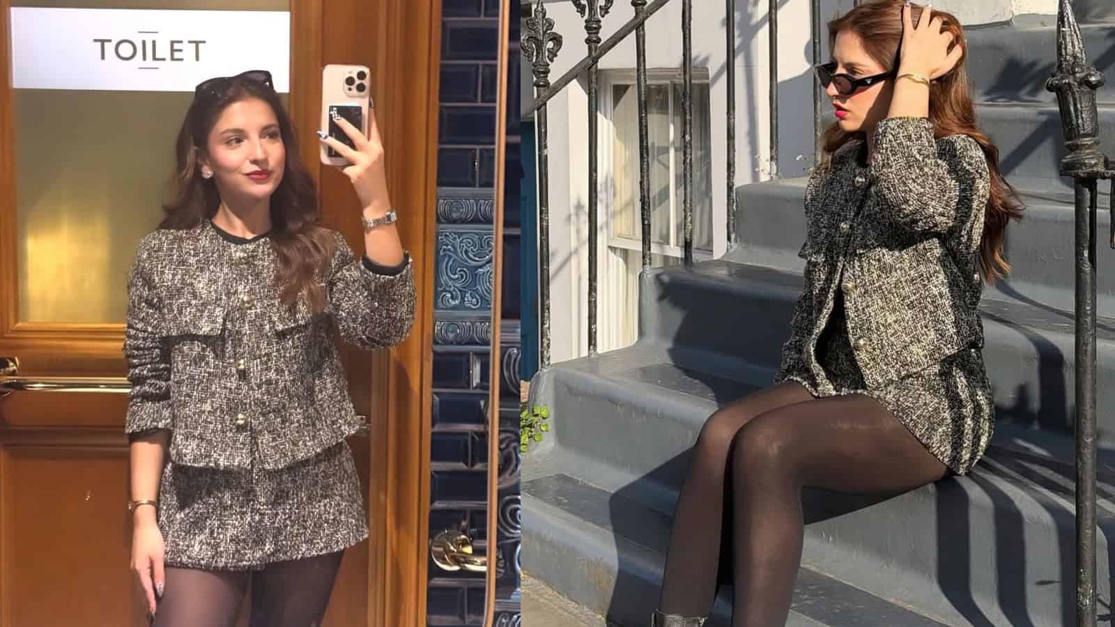 A woman taking a mirror selfie in a stylish mini skirt and blazer outfit, with a