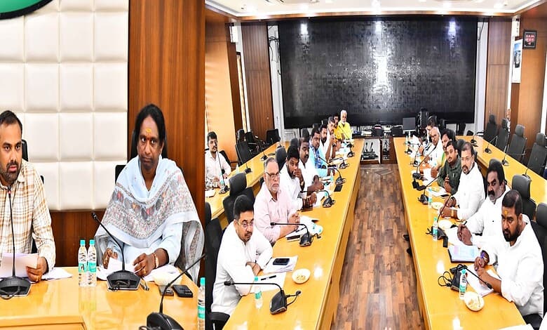 The Siasat Daily: Business meeting with diverse professionals in a modern conference room.
