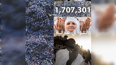 Large crowd of people gathered outdoors, with a woman in traditional attire and a man clapping, during a.