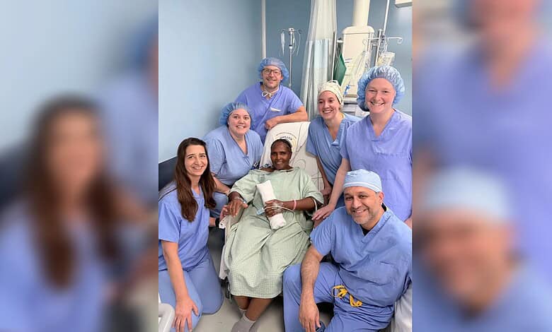 Recovered heart surgery patient poses with members of the visiting cardiac team in Nairobi.