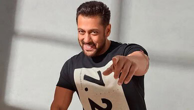 Salman Khan smiling and pointing at the camera, promoting his upcoming film.