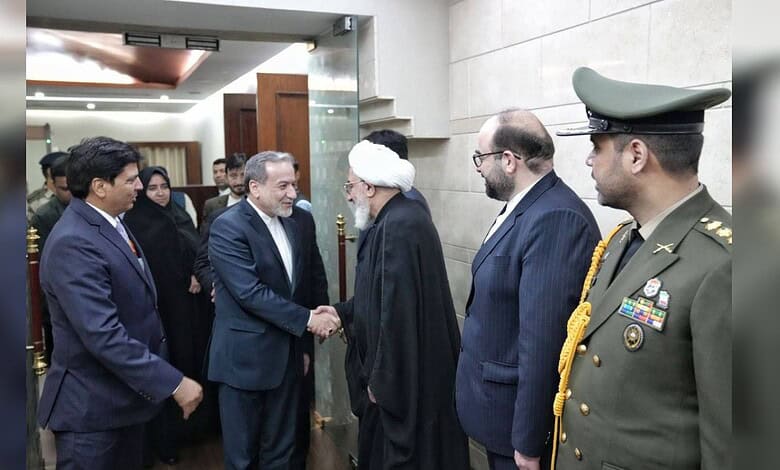 A group of officials, including a military officer and government representatives, greeting a distinguish.